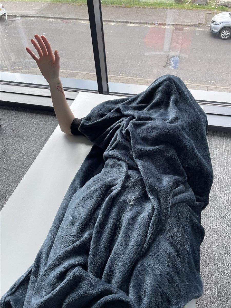 Reference photography of a raised hand used for modeling proportions